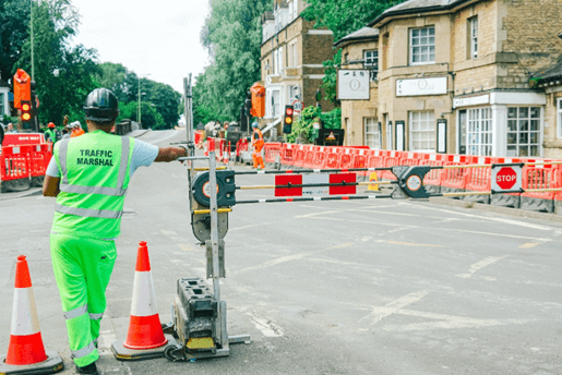 Man in reflective jacket standing by SentriGate portable vehicle access gate