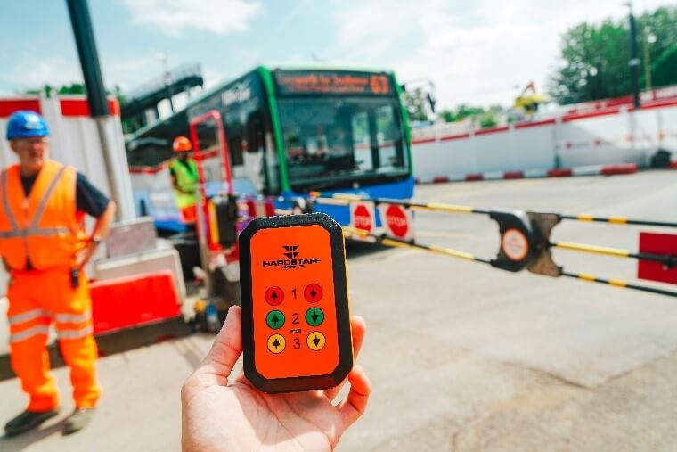 Close up photograph of the SentriGate portable vehicle access gate control with bus in background