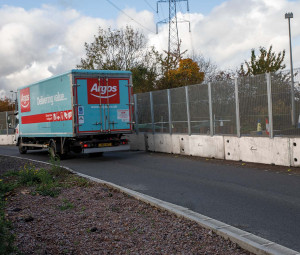 Argos truck driving past Multibloc and fence along the A1